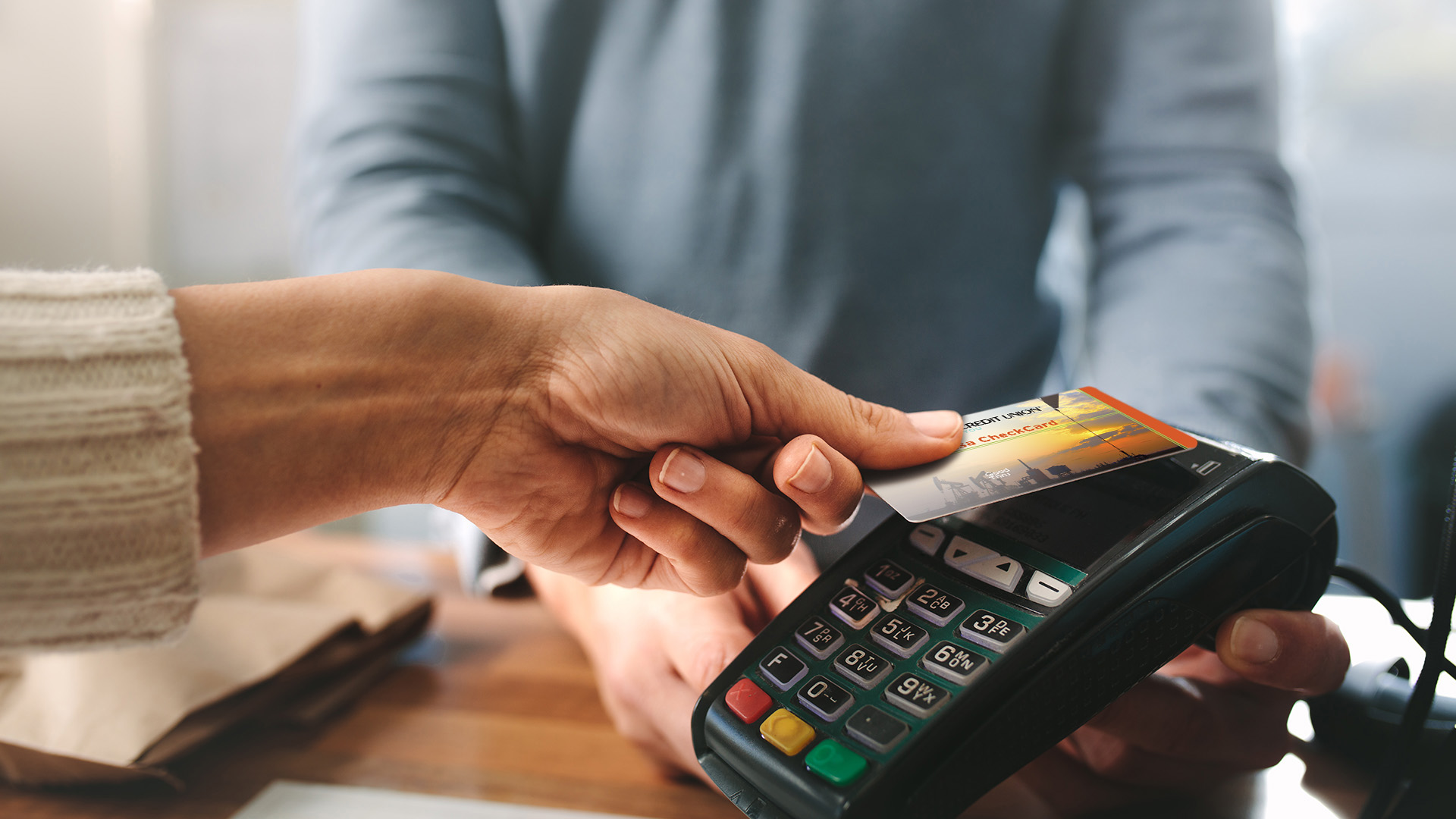 Person using contact card payment at checkout