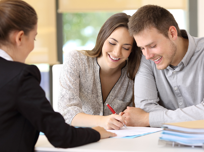 Man and Woman signing mortgage closing papers