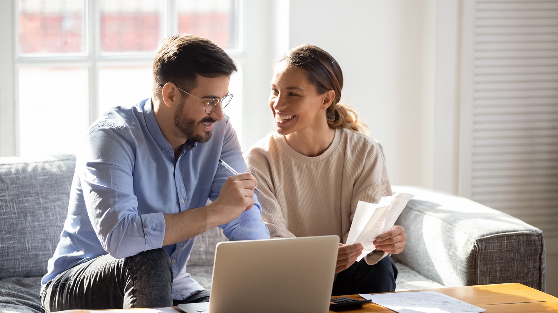 man and woman working on finances