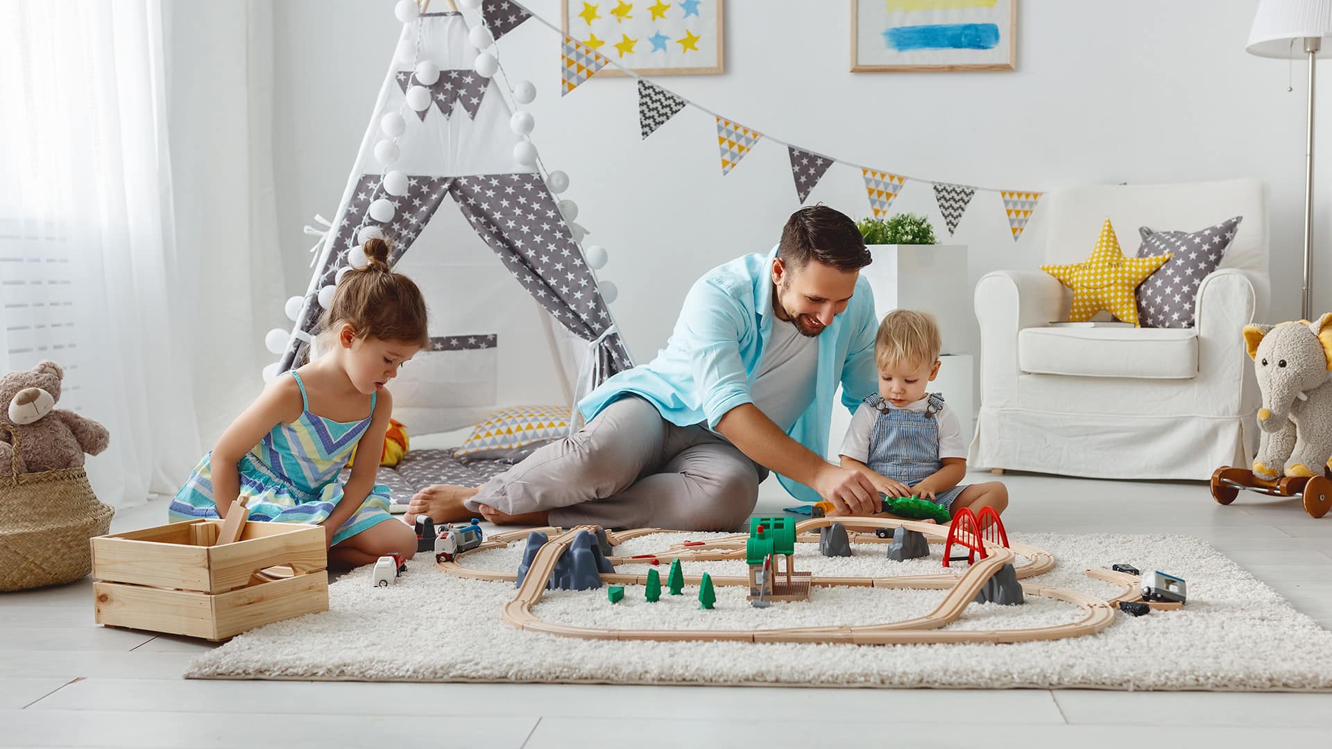 father and children playing with toys