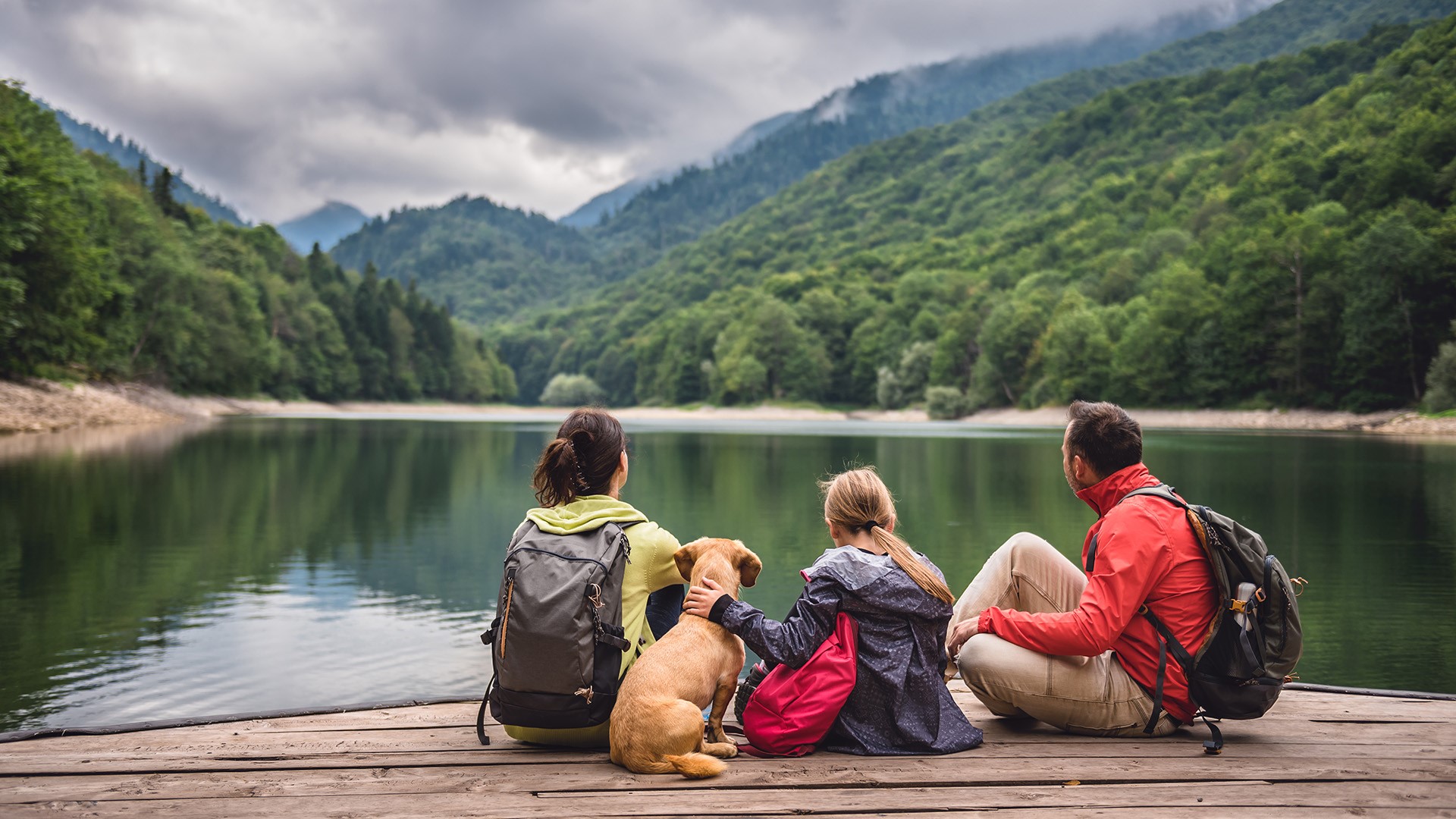 family sitting on dock