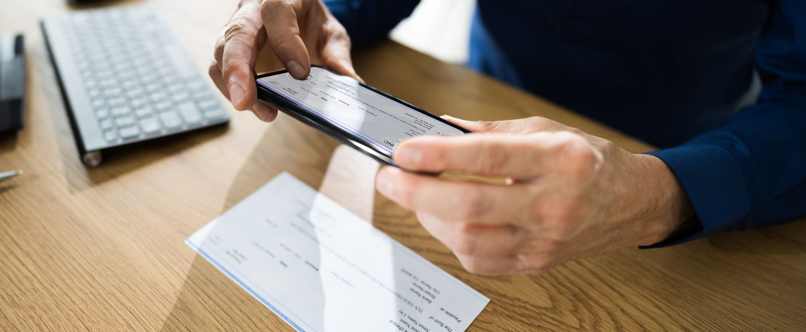 person taking picture of a check with a phone
