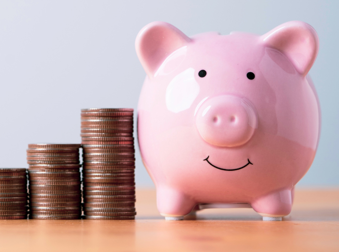 Piggy bank beside stacked coins