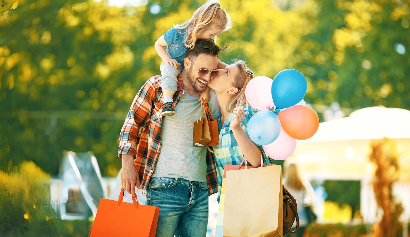 Family with shopping bags and balloons