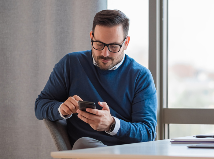 Professional man looking at mobile phone